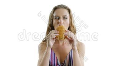 年轻<strong>瘦瘦</strong>的漂亮女人正在白色背景下吃汉堡包。 <strong>瘦</strong>女孩饿了